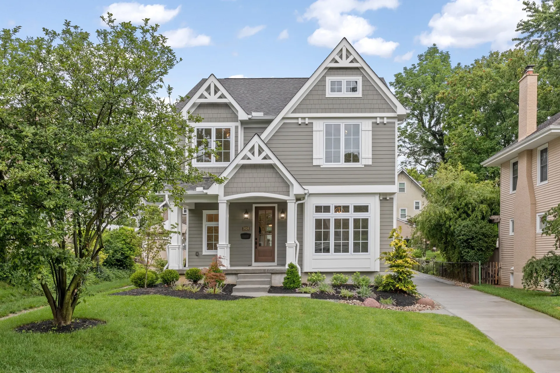 3024 Griest Ave. in Mt. Lookout: a grey-sided two-story home with white trim, a steep front gable and a covered front porch above a broad green lawn